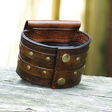 strappy brown leather wrist wallet cuff for bikers and travelers with secret pocket